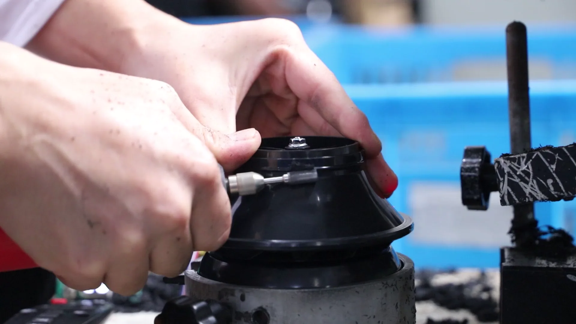 Close-up of a fan component being checked at a production workstation